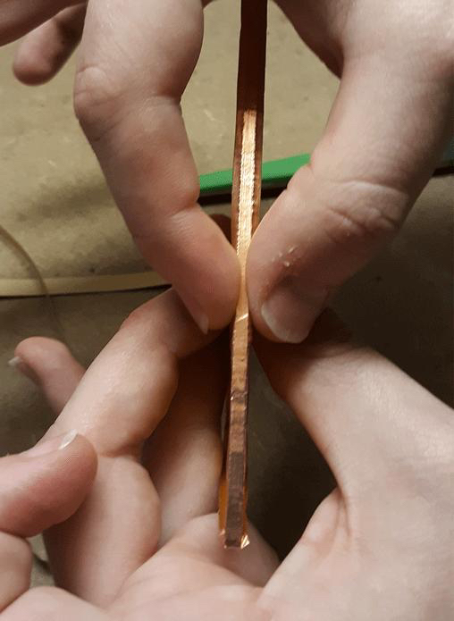 Close-up of copper foil edge handling