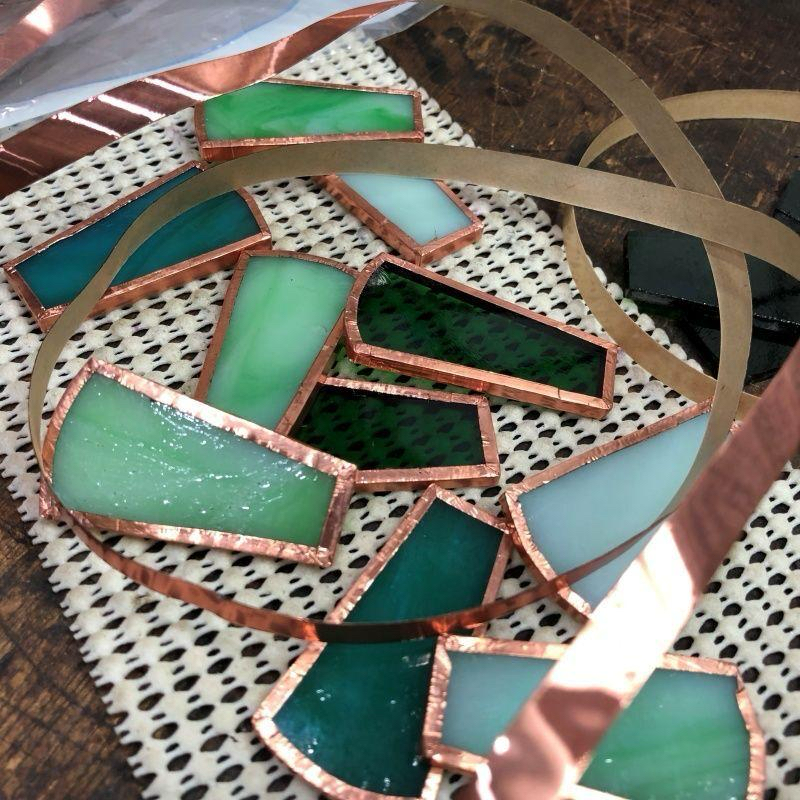 Stained glass pieces wrapped with copper foil before soldering